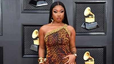 Megan Thee Stallion channelled the wildness of the jungle and her fierce style on the Grammy Awards red carpet in a custom Roberto Cavalli gown doused with tiger print and embellishments. She teamed the look with bold make-up, standout jewels and accessories. (AFP) Megan Thee Stallion channelled the wildness of the jungle and her fierce style on the Grammy Awards red carpet in a custom Roberto Cavalli gown doused with tiger print and embellishments. She teamed the look with bold make-up, standout jewels and accessories. (AFP)
