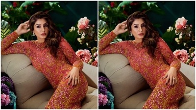 The red shimmery gown came decorated in shades of yellow and silver. In white and blue earrings from Mozzati, Raveena accessorised her look to perfection. (Instagram/@officialraveenatandon)
