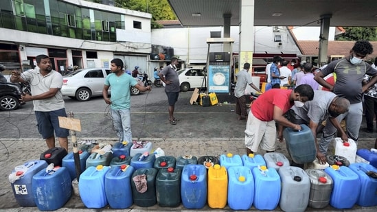 Sri Lankans gather at a fuel station to buy diesel before the beginning of curfew in Colombo, Sri Lanka.&nbsp;(AP)