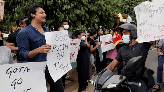People shout slogans against Sri Lanka's President Gotabaya Rajapaksa on a main road in Colombo.(REUTERS)