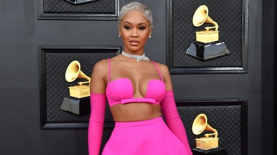 Saweetie chose a bright pink custom Valentino skirt and bralette set with sleek Opera gloves and a diamond choker necklace. The US rapper's platinum blonde hair took the glam quotient up by a notch.(AFP)