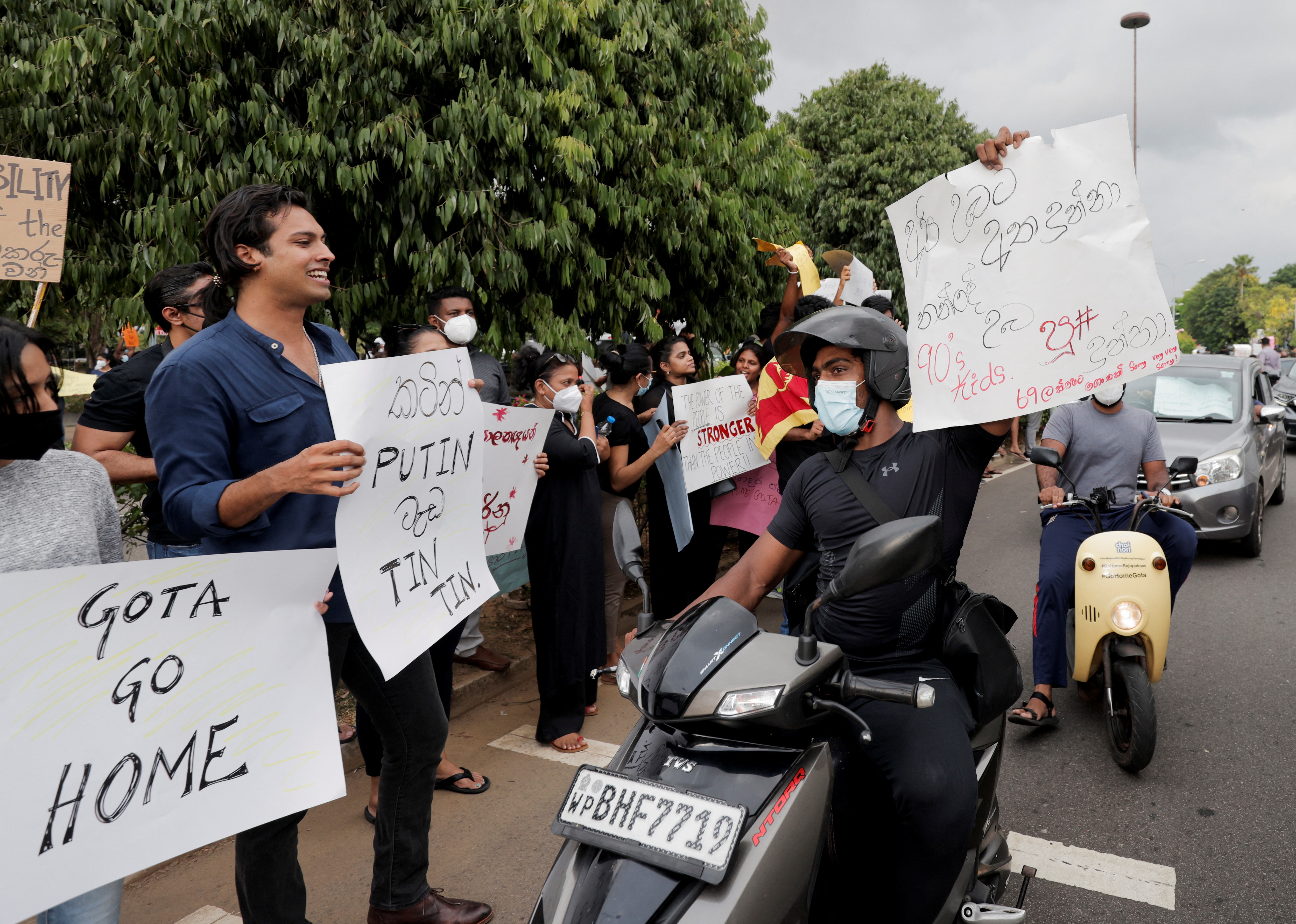 People shout slogans against Sri Lanka's President Gotabaya Rajapaksa on a main road in Colombo. (REUTERS)