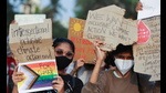 People hold placards during a People hold placards during a