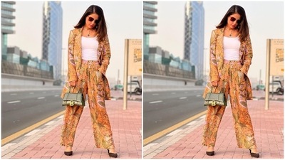 Hina teamed the blazer with matching high-waisted pants in the same floral print and mustard yellow shade. It features pleated details and a flared hem. In the end, Hina rounded off the ensemble with a white spaghetti-strapped tank top. (Instagram/@realhinakhan) Hina teamed the blazer with matching high-waisted pants in the same floral print and mustard yellow shade. It features pleated details and a flared hem. In the end, Hina rounded off the ensemble with a white spaghetti-strapped tank top. (Instagram/@realhinakhan)