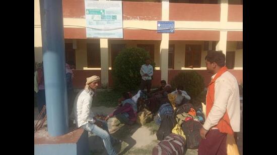 Migrant workers from Bihar at Awantipora railway station in south Kashmir’s Pulwama district on Tuesday. (HT Photo)