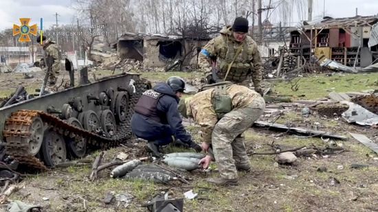 State Emergency Service members collect ordnance after Russia's withdrawal from the area, Bucha, Ukraine (REUTERS)