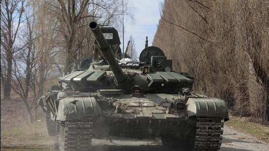 A Ukrainian service member drives a captured Russian T-72 tank, in the recently liberated village of Lukianivka, in Kyiv region. (REUTERS)