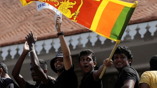 A man waves a Sri Lankan flag as people shout slogans against Sri Lanka's President Gotabaya Rajapaksa and demand that Rajapaksa family politicians step down, during a protest amid the country's economic crisis,&nbsp;(REUTERS)