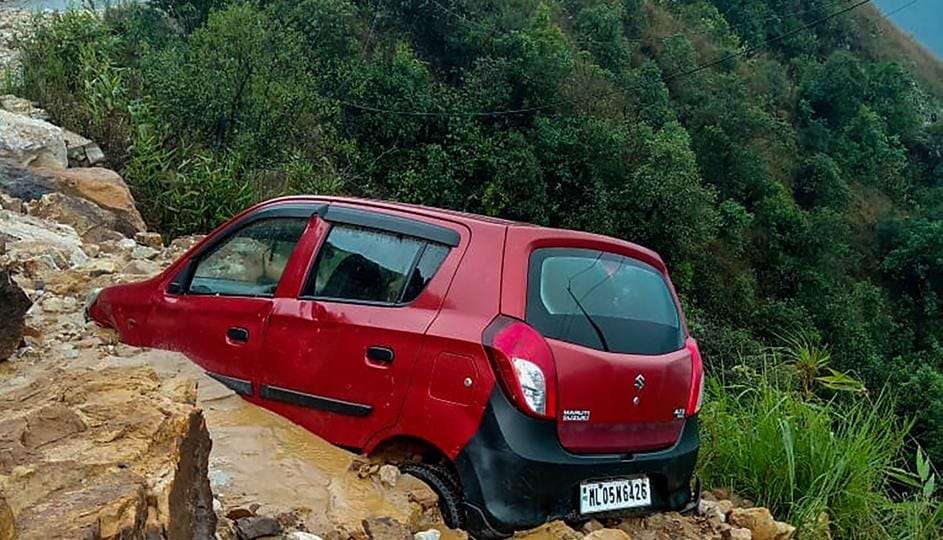 A car stuck in debris on the blocked NH-40 Shillong-Dawki road after landslides due to incessant rains, near Siatbakon village in Meghalaya, on Monday. (PTI) A car stuck in debris on the blocked NH-40 Shillong-Dawki road after landslides due to incessant rains, near Siatbakon village in Meghalaya, on Monday. (PTI)