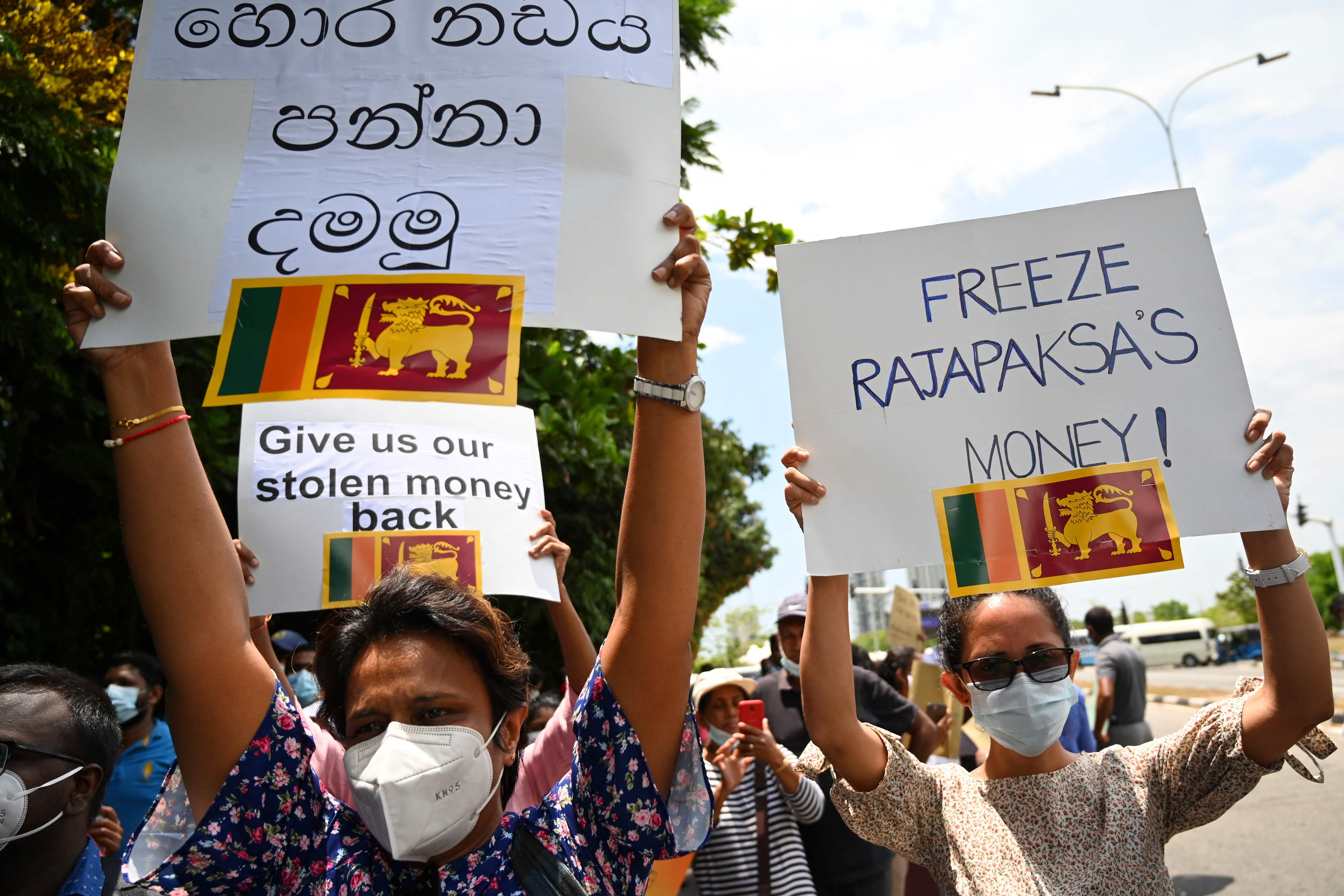 Demonstrators hold placards and shout slogans during a protest against the surge in prices and shortage of fuel and other essential commodities near the parliament building in Colombo on April 5, 2022. (AFP) Demonstrators hold placards and shout slogans during a protest against the surge in prices and shortage of fuel and other essential commodities near the parliament building in Colombo on April 5, 2022. (AFP)