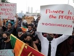 People hold placards as they demand Sri Lanka's President Gotabaya Rajapaksa to resign in Colombo on Wednesday.