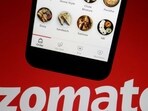 The app of Indian food delivery company Zomato is seen on a mobile phone above its logo displayed in this illustration picture.(REUTERS)