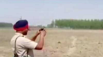 A clip of the Gurdaspur clash that surfaced on Wednesday shows two cops standing at a small distance from the spot with one recording a video on his mobile phone. A clip of the Gurdaspur clash that surfaced on Wednesday shows two cops standing at a small distance from the spot with one recording a video on his mobile phone.