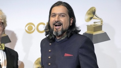 Ricky Kej poses in the press room with the award for best new age album for "Divine Tides" at the 64th Annual Grammy Awards at the MGM Grand Garden Arena on Sunday. (AP)