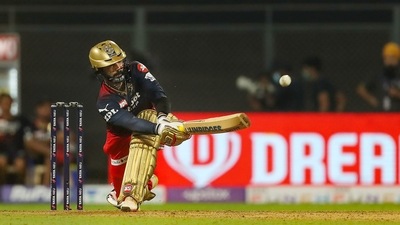 Dinesh Karthik of Royal Challengers Bangalore plays a shot during match 13 of the Indian Premier League 2022 cricket tournament between the Rajasthan Royals and the Royal Challengers Bangalore, at the Wankhede Stadium in Mumbai, Tuesday, April 5, 2022. (PTI) Dinesh Karthik of Royal Challengers Bangalore plays a shot during match 13 of the Indian Premier League 2022 cricket tournament between the Rajasthan Royals and the Royal Challengers Bangalore, at the Wankhede Stadium in Mumbai, Tuesday, April 5, 2022. (PTI)