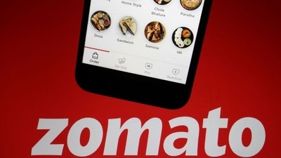 The app of Indian food delivery company Zomato is seen on a mobile phone above its logo displayed in this illustration picture. (REUTERS)