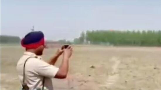A clip of the Gurdaspur clash that surfaced on Wednesday shows two cops standing at a small distance from the spot with one recording a video on his mobile phone.
