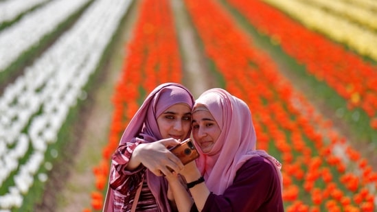 Girls take a selfie inside Kashmir's tulip garden on the foothills of the Zabarwan mountain range in Srinagar&nbsp;(REUTERS/Danish Ismail)