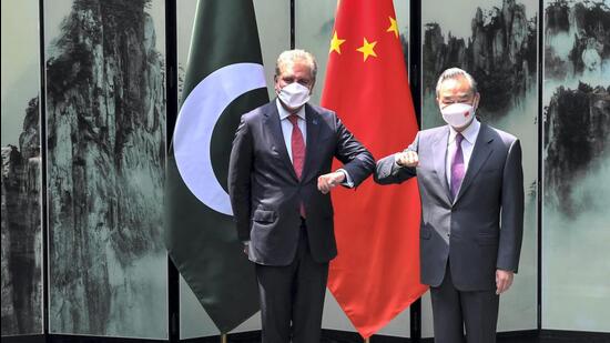 Chinese Foreign Minister Wang Yi poses for photos with his Pakistan counterpart Shah Mahmood Qureshi before they head their bilateral meeting in Tunxi, eastern China's Anhui Province on March 30, 2022. (AP/FILE) Chinese Foreign Minister Wang Yi poses for photos with his Pakistan counterpart Shah Mahmood Qureshi before they head their bilateral meeting in Tunxi, eastern China's Anhui Province on March 30, 2022. (AP/FILE)