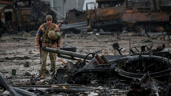 A Ukrainian service member inspects a compound of the Antonov airfield, in Kyiv region, Ukraine.(REUTERS)