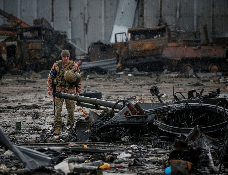 A Ukrainian service member inspects a compound of the Antonov airfield, in Kyiv region, Ukraine. (REUTERS)
