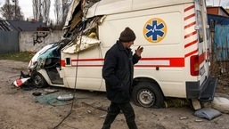 A local man walks past a damaged ambulance, as Russia's attack on Ukraine continues, in the settlement of Hostomel, outside Kyiv, Ukraine.