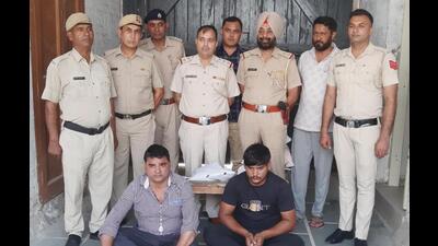 Ambala ex-councillor Rajesh Kumar and his son in custody after attacking a police team during an earlier raid. (HT Photo)