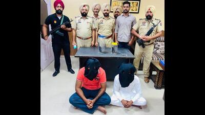 Gurpreet Singh and Manpreet Singh, alias Manna, both associates of the Lawrence Bishnoi and Goldy Brar gangs, in the custody of Mohali police’s crime investigating agency on Thursday. (HT Photo) Gurpreet Singh and Manpreet Singh, alias Manna, both associates of the Lawrence Bishnoi and Goldy Brar gangs, in the custody of Mohali police’s crime investigating agency on Thursday. (HT Photo)