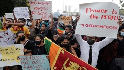 People hold placards as they demand Sri Lanka's President Gotabaya Rajapaksa to resign after his government lost its majority in the parliament, amid the country's economic crisis. REUTERS/Dinuka Liyanawatte