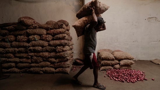 nA man carries sacks of red onions at a market, amid the country's economic crisis in Colombo, Sri Lanka, April 7, 2022. REUTERS/Dinuka Liyanawatte(REUTERS)