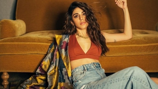 Acing the street style look, Alaya F posed for the camera in a tanned bralette, denim and printed cape.(Instagram/@alayaf)