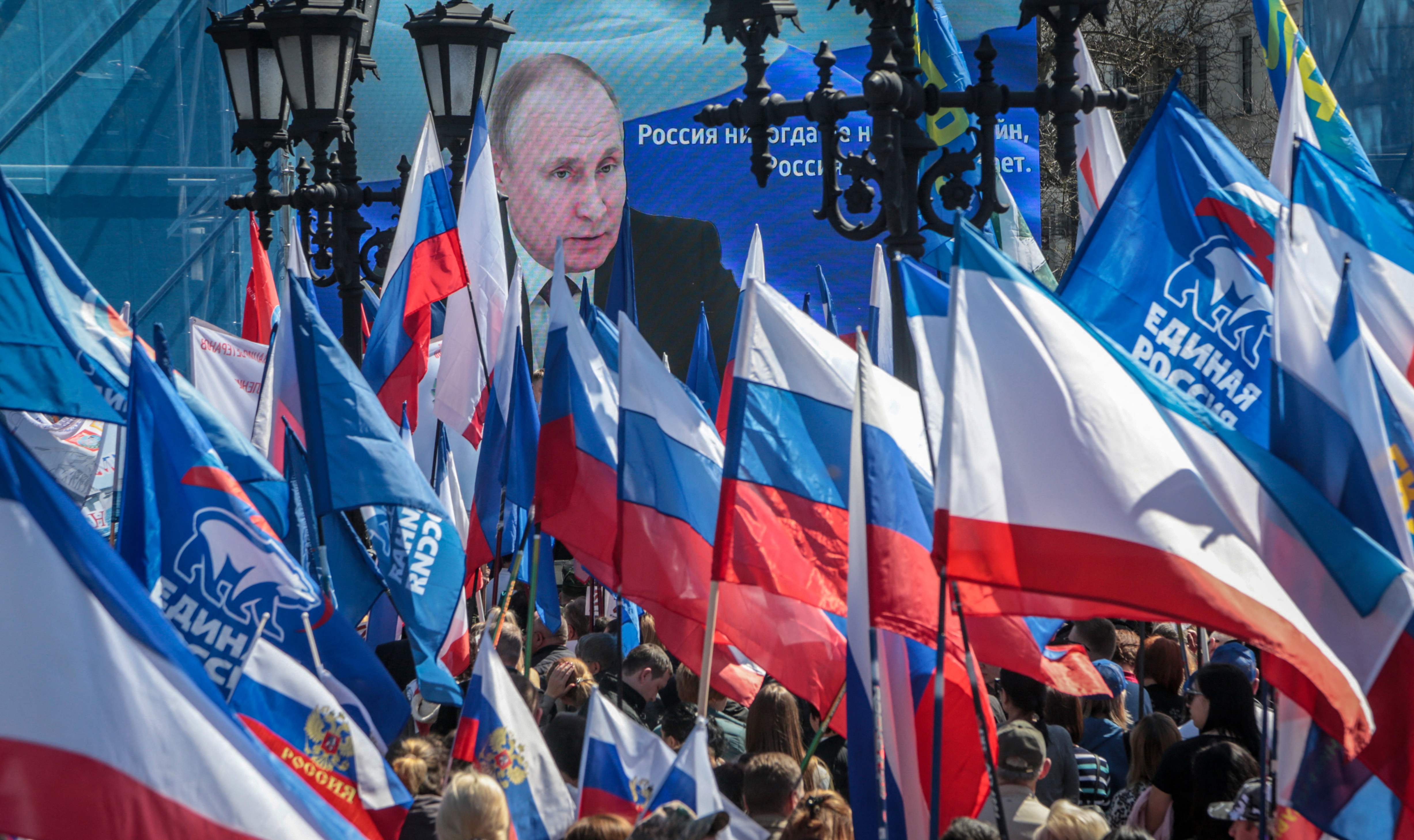 People wave flags during a rally in support of the Russian military operation in Ukraine, in Simferopol, Crimea on April 7, 2022.&nbsp; (AFP)