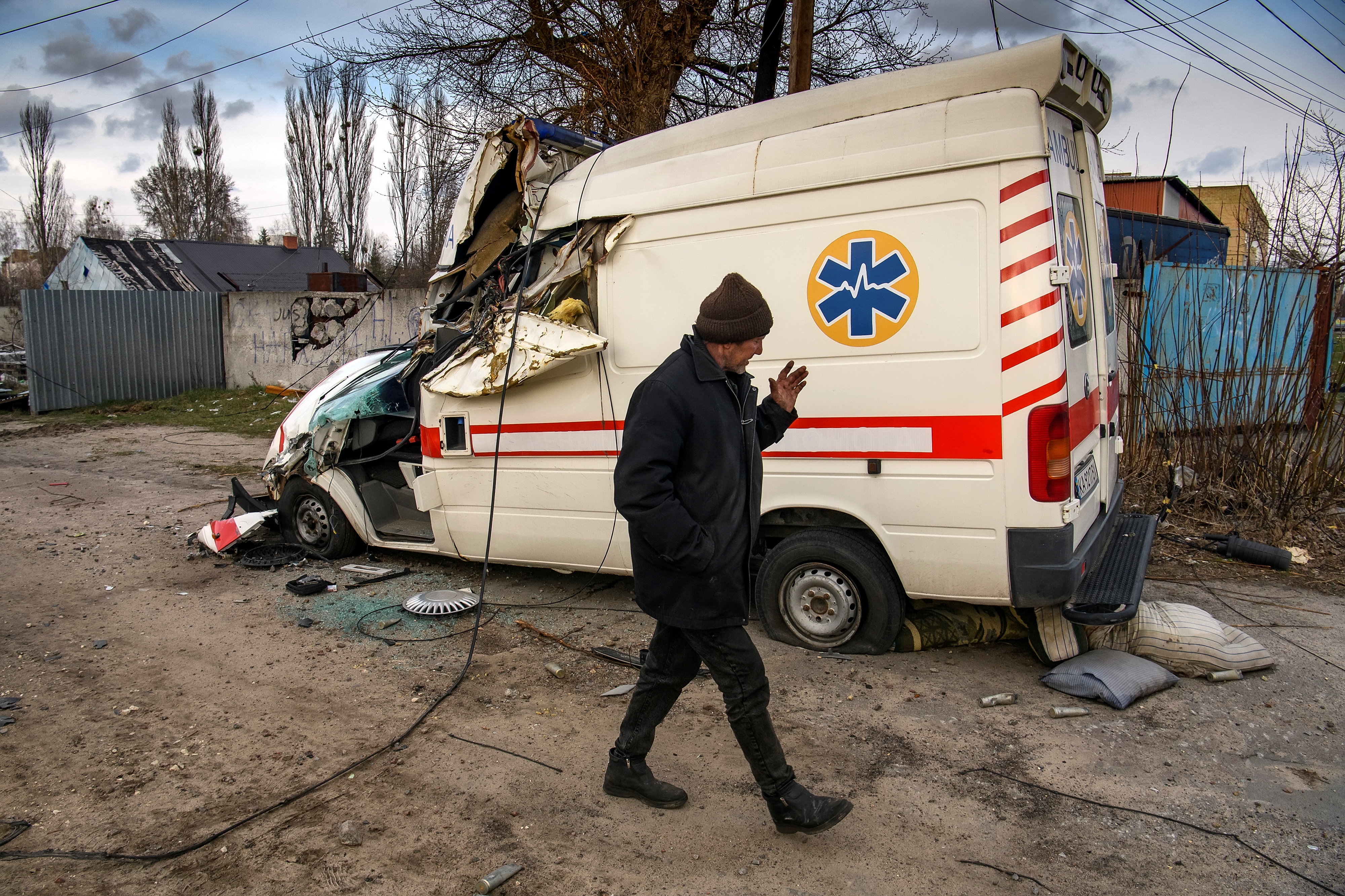 A local man walks past a damaged ambulance, as Russia's attack on Ukraine continues, in the settlement of Hostomel, outside Kyiv, Ukraine. (Reuters)