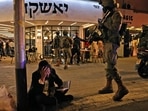 An ultra-Orthodox Jewish man reacts while holding a volume of the Book of Psalms while security forces gather behind at the scene of a shooting attack in Dizengoff Street in the centre of Israel's Mediterranean coastal city of Tel Aviv.(AFP) An ultra-Orthodox Jewish man reacts while holding a volume of the Book of Psalms while security forces gather behind at the scene of a shooting attack in Dizengoff Street in the centre of Israel's Mediterranean coastal city of Tel Aviv.(AFP)