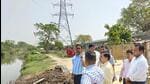 The Greater Noida authority chief executive officer Narendra Bhooshan and others at Kasna village on Friday. (Sourced)