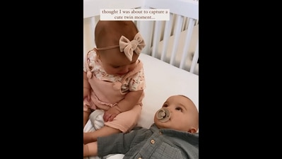 The cute image, taken from the Instagram video, shows the twin babies looking at each other. (Instagram/@heatherfernxo)