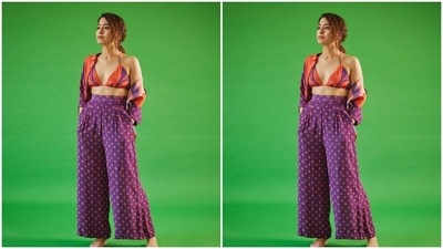 Shweta paired an orange and blue printed bra with a printed cropped shirt. She teamed her look with a printed blue high-waisted pair of palazzos with wide legs. (Instagram/@battatawada)