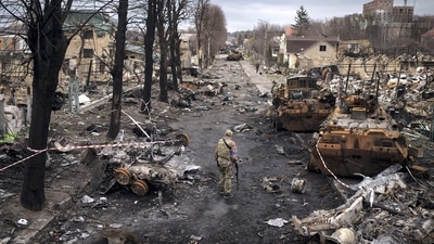 A Ukrainian serviceman walks amid destroyed Russian tanks in Bucha, on the outskirts of Kyiv, Ukraine. (AP) A Ukrainian serviceman walks amid destroyed Russian tanks in Bucha, on the outskirts of Kyiv, Ukraine. (AP)