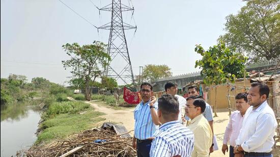 The Greater Noida authority chief executive officer Narendra Bhooshan and others at Kasna village on Friday. (Sourced)