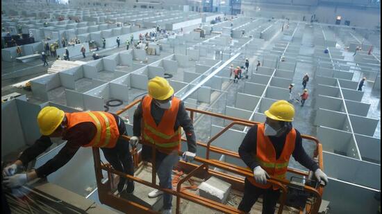 Workers labour to convert the National Exhibition and Convention Center into a makeshift hospital for Covid-19 patients, in Shanghai, China , on Thursday. (REUTERS)