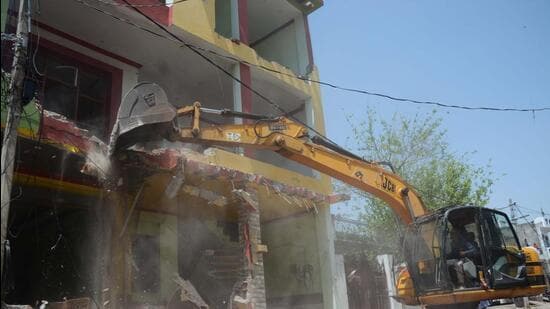 A bulldozer in action in Lucknow . (Deepak Gupta/HT Photo)