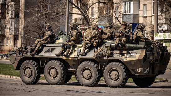 Ukrainian soldiers sit on a armoured military vehicule in the city of Severodonetsk, Donbass region.