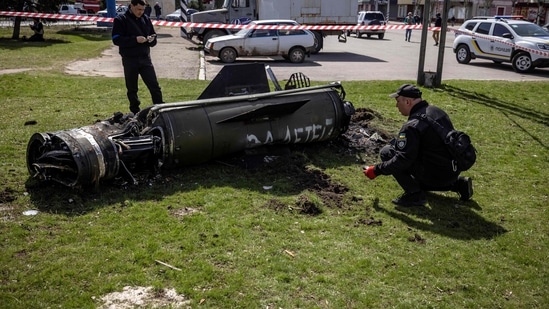 ldUkrainian police inspect the remains of a large rocket with the words "for our children" in Russian next to the main building of a train station in Kramatorsk, eastern Ukraine, that was being used for civilian evacuations, that was hit by a rocket attack killing at least 35 people, on April 8, 2022. (Photo by FADEL SENNA / AFP)(AFP)