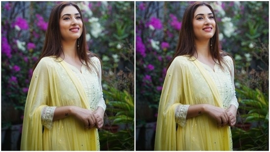 Disha teamed the long kurta with matching palazzo pants featuring similar thread embroidery and mirror work. The flared hems make it a comfortable pick for summers. A yellow chiffon dupatta adorned with ruffle borders and sequins, draped on the shoulders, completed Disha's shoot outfit.(Instagram/@dishaparmar)
