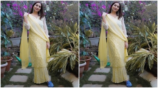 Disha's ensemble features a long chiffon kurta in an ombré pastel yellow shade. It comes with a V neckline, sheer sleeves, intricate thread embroidery, patti borders on the cuffs, and heavy mirror embellishments done all over.(Instagram/@dishaparmar)