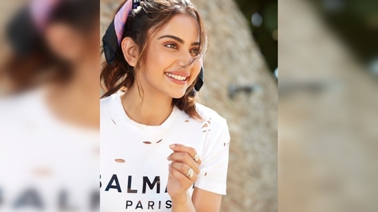 Rakul Preet donned separates that comprise a t-shirt from the luxury brand Balmain Paris and teamed with a short asymmetrical metallic skirt.(Instagram/@rakulpreet)