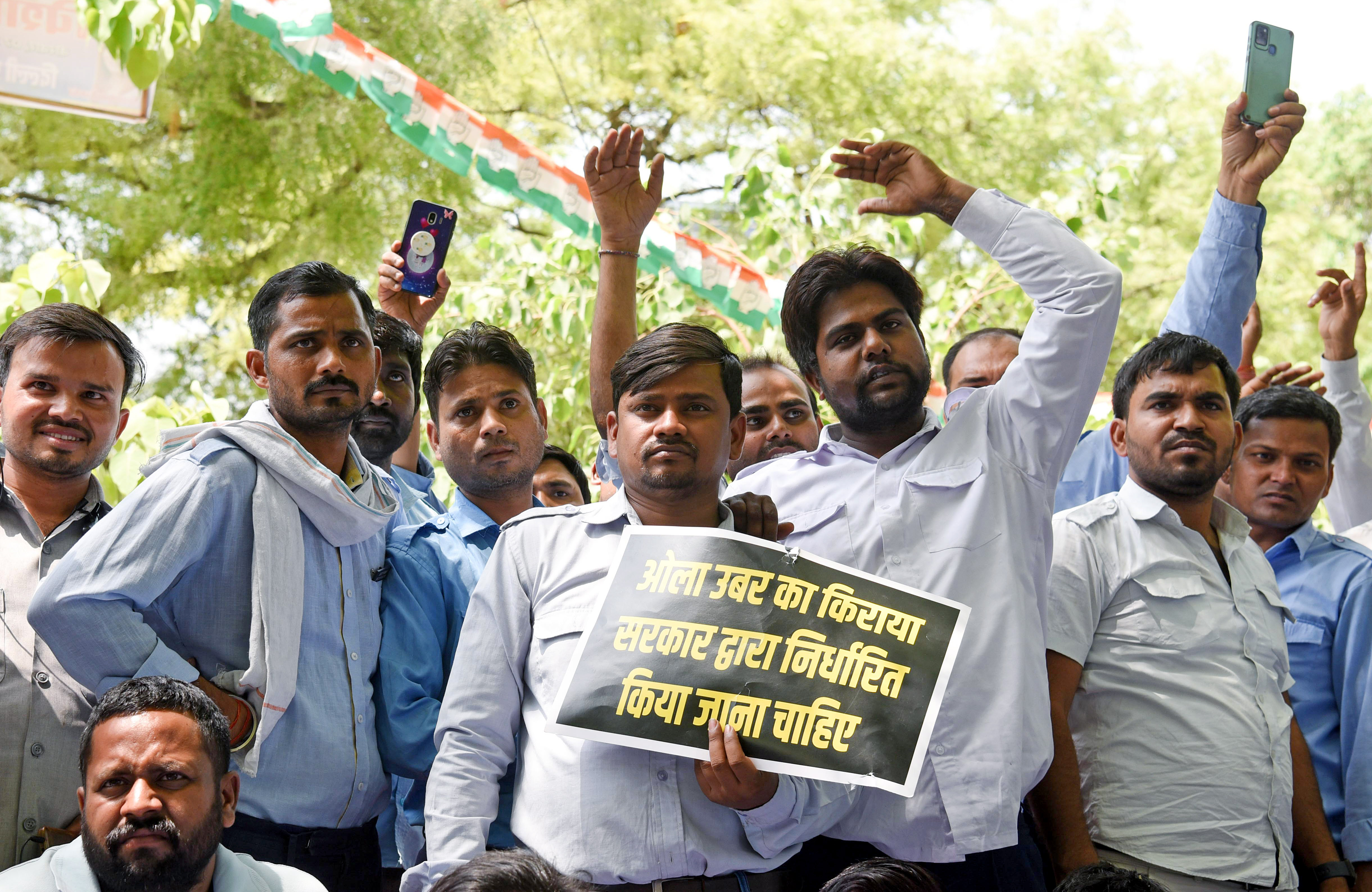 Taxi drivers including Ola and Uber holding a placard protest against the continuous hike in fuel prices, at Jantar Mantar, in New Delhi on April 8, 2022. (ANI Photo) Taxi drivers including Ola and Uber holding a placard protest against the continuous hike in fuel prices, at Jantar Mantar, in New Delhi on April 8, 2022. (ANI Photo)
