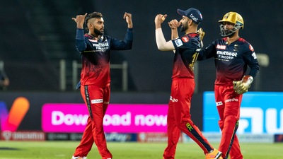 Wanindu Hasaranga of Royal Challengers Bangalore celebrates with teammate Virat Kohli after the wicket of Dewald Brevis. (PTI) Wanindu Hasaranga of Royal Challengers Bangalore celebrates with teammate Virat Kohli after the wicket of Dewald Brevis. (PTI)