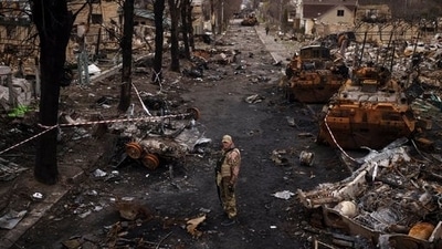 A Ukrainian serviceman stands amid destroyed Russian tanks in Bucha, on the outskirts of Kyiv, Ukraine (AP) A Ukrainian serviceman stands amid destroyed Russian tanks in Bucha, on the outskirts of Kyiv, Ukraine (AP)