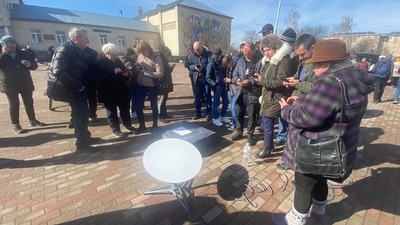 In this image shared by Ukrainian journalist Kristina Berdynskykh, residents of a village in Ukraine's Kyiv region can be seen using mobile phones to access internet via Starlink. (Facebook / Kristina Berdynskykh) In this image shared by Ukrainian journalist Kristina Berdynskykh, residents of a village in Ukraine's Kyiv region can be seen using mobile phones to access internet via Starlink. (Facebook / Kristina Berdynskykh)